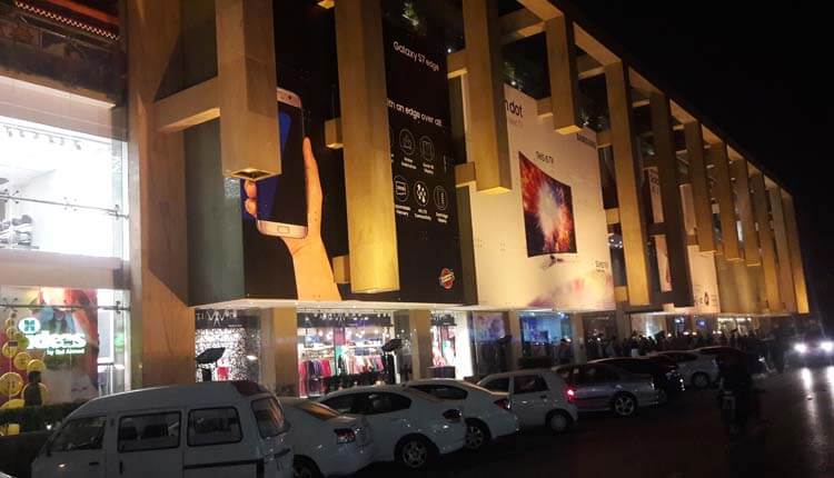 night view of a mall with parked vehicles